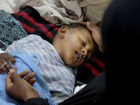 In this May 12, 2017 photo, released by UNICEF, a child is treated for suspected cholera infection at a hospital in Sanaa, Yemen. An Associated Press investigation finds that Yemen's massive cholera epidemic was aggravated by corruption and official intransigence. The investigation has found that both the Iranian-backed Houthis rebels and their main adversary in the war -- the U.S.- and Saudi-backed government that controls southern Yemen -- impeded efforts by relief groups to stem the epidemic. (UNICEF via AP)