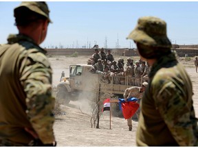 Australian and New Zealand coalition forces participate in a training mission with Iraqi army soldiers at Taji Base, north of Baghdad, Iraq, Wednesday, April 17, 2019. A month after the defeat of the Islamic State group in Syria and Iraq, the U.S.-led international coalition has turned its attention to training Iraqi forces to secure the country against lingering threats posed by IS cells operating in the countryside.