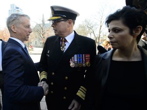 Liberal MP Andrew Leslie shakes hands with Vice Admiral Mark Norman as he arrives to court in Ottawa on Wednesday, May 8, 2019.