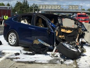Emergency personnel work a the scene where a Tesla electric SUV crashed into a barrier on U.S. Highway 101 in Mountain View, Calif. in March 2018.
