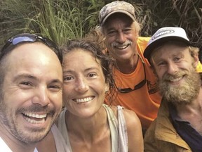 Resident Amanda Eller, second from left, poses for a photo after being found by searchers, Javier Cantellops, far left, Helmer and Chris Berquist above the Kailua reservoir in East Maui, Hawaii, on May 24, 2019.