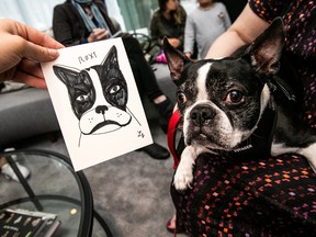 Laura Supnik shows a portrait of Roxy, a French bulldog, during a resident event at a luxury development in Manhattan.