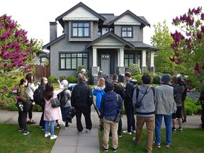 A crowd of media stands in front of the home of Huawei Technologies Chief Financial Officer Meng Wanzhou on May 7, 2019 in Vancouver.