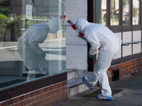 A forensic expert arrives to secure evidence on May 13, 2019 in a cordoned off house in Wittingen, northern Germany, where two bodies were found during investigations into the deaths of three people discovered in a Bavarian hotel room.