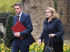 In this file photo taken on April 8, 2019 Britain's then- Defence Secretary Gavin Williamson (L) and Britain's International Development Secretary and Minister for Women and Equalities Penny Mordaunt arrive in Downing street in central London.