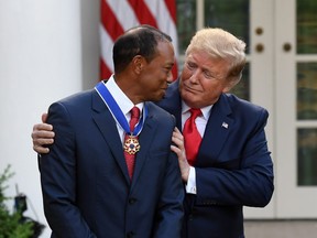 U.S. President Donald Trump presents US golfer Tiger Woods with the Presidential Medal of Freedom during a ceremony in the Rose Garden of the White House in Washington, DC, on May 6, 2019.