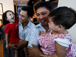 Reuters journalists Wa Lone (R) and Kyaw Soe Oo celebrate with their children after being freed freed from prison after a presidential amnesty in Yangon on May 7, 2019.