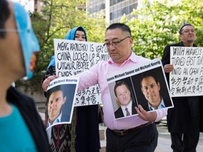 Uyghur activists protest outside a court appearance for Huawei Chief Financial Officer, Meng Wanzhou, at the British Columbia Supreme Court in Vancouver, on May 8, 2019.