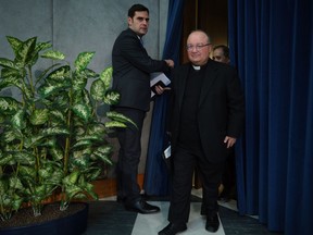 Malta's Archbishop Charles Scicluna, right, is welcomed by Vatican spokesman Alessandro Gisotti as he arrives for a press conference to present the new sex abuse law, at the Vatican's press room, Rome, Thursday, May 9, 2019. Pope Francis issued a groundbreaking law Thursday requiring all Catholic priests and nuns around the world to report clergy sexual abuse and cover-up by their superiors to church authorities, in an important new effort to hold the Catholic hierarchy accountable for failing to protect their flocks.