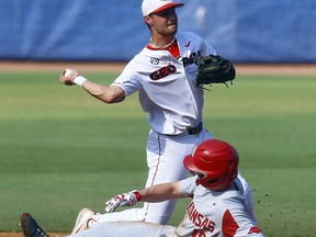 Georgia shortstop Cam Shepherd (7) throws to first after getting the force out on Arkansas' Heston Kjerstad, who slides into second base during the first inning of a Southeastern Conference tournament NCAA college baseball game, Thursday, May 23, 2019, in Hoover, Ala.