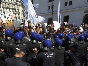 Algerian students face riot police officers during an anti-government demonstration in Algiers, Tuesday, May 14, 2019. Former Algerian President Abdelaziz Bouteflika resigned April 2 2019 under pressure from the protesters, and the army chief.