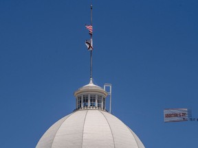 Legal abortion supporters fly a banner reading Abortion is OK over the Alabama State Capitol building in downtown Montgomery, Ala., on Wednesday May 15, 2019. Alabama HB314, the near-total ban on abortion bill, passed the Alabama legislature on Tuesday.