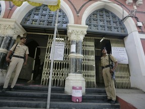 Indian policemen stand guard outside a vote counting center in Ahmadabad, India, Wednesday, May 22, 2019. India's Election Commission has rejected opposition fears of possible tampering of electronic voting machines ahead of Thursday's vote-counting to determine the outcome of the country's mammoth national elections. Authorities on Wednesday tightened security at counting centers where the electronic voting machines have been kept in strong rooms across the country.