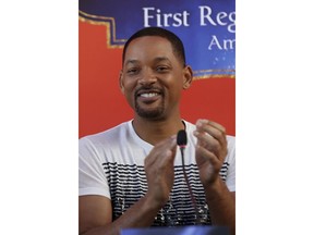 U.S. actor Will Smith applauds during a news conference with the director Guy Ritchie and stars Mena Massoud and Naomi Scott, ahead of the regional launching of Disney's live-action "Aladdin," in the Jordanian capital Amman, Monday, May 13, 2019. The film opens in Middle East theaters May 23, 2019.