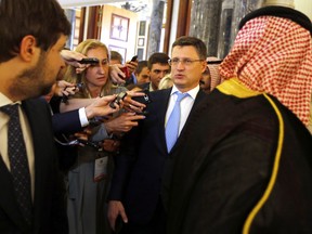 Russian Minister of Energy Alexander Novak is surrounded by reporters as he arrives to attend a meeting of the energy ministers from OPEC and its allies to discuss prices and production cuts, in Jiddah, Saudi Arabia, Sunday, May 19, 2019. The meeting takes places as tensions flare in the Persian Gulf after the U.S. ordered bombers and an aircraft carrier to the region over an unexplained threat they perceive from Iran, which comes a year after the U.S. unilaterally pulled out of Tehran's nuclear deal with world powers and reimposed sanctions on Iranian oil.