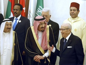 Kuwait's Emir Sheikh Sabah al-Ahmad al-Jaber al-Sabah, left, and Saudi Arabia's King Salman, center, listen to Tunisian President Beji Caid Essebsi, right, during a group photo session ahead of an emergency Arab summit in Mecca, Saudi Arabia, Thursday, May 30, 2019. King Salman opened an emergency summit of Gulf Arab leaders in the holy city of Mecca on Thursday with a call for the international community to use all means to confront Iran, but he also said the kingdom extends its hand for peace.