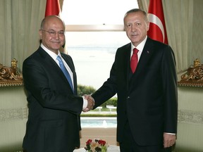 Turkey's President Recep Tayyip Erdogan, right, and Iraq's President Barham Salih shake hands before a meeting in Ankara, Turkey, Tuesday, May 28, 2019. The two expected to discus bileteral and regional issues, including Syria.(Presidential Press Service via AP, Pool)