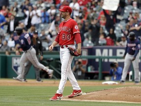 Los Angeles Angels starting pitcher Matt Harvey walks off the mound after giving up a three-run home run to Minnesota Twins' Jonathan Schoop, background left, during the second inning of a baseball game Thursday, May 23, 2019, in Anaheim, Calif.