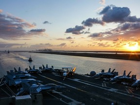 In this Thursday, May 9, 2019 photo released by the U.S. Navy, the Nimitz-class aircraft carrier USS Abraham Lincoln transits the Suez Canal in Egypt. The aircraft carrier and its strike group are deploying to the Persian Gulf on orders from the White House to respond to an unspecified threat from Iran.