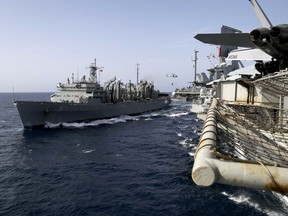 In this Sunday, May 19, 2019, photo released by the U.S. Navy, the fast combat support ship USNS Arctic transports cargo to the Nimitz-class aircraft carrier USS Abraham Lincoln during a replenishment-at-sea in the Arabian Sea.