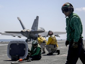 In this Monday, May 20, 2019 photo, released by U.S. Navy, an F/A-18E Super Hornet from the "Jolly Rogers" of Strike Fighter Squadron (VFA) 103 launches from the flight deck of the Nimitz-class aircraft carrier USS Abraham Lincoln (CVN 72) on Arabian Sea.