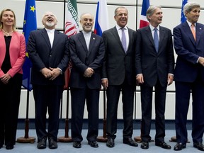 FILE - In this July 14, 2015 file photo, from left to right: European Union High Representative Federica Mogherini, Iranian Foreign Minister Mohammad Javad Zarif, Head of the Iranian Atomic Energy Organization Ali Akbar Salehi, Russian Foreign Minister Sergey Lavrov, British Foreign Secretary Philip Hammond and U.S. Secretary of State John Kerry pose for a group picture at the United Nations building in Vienna, Austria.  Iran threatened Wednesday, May 8, 2019, to resume higher enrichment of uranium in 60 days if world powers fail to negotiate new terms for its 2015 nuclear deal, an agreement that capped over a decade of hostility between Tehran and the West over its atomic program.