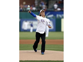 Baylor women's basketball head coach Kim Mulkey throws out the ceremonial first pitch before a baseball game between the St. Louis Cardinals and the Texas Rangers in Arlington, Texas, Friday, May 17, 2019.