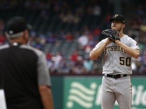 Pittsburgh Pirates starting pitcher Jameson Taillon reacts as manager Clint Hurdle walks to the mound to relieve him against the Texas Rangers during the seventh inning of a baseball game Wednesday May 1, 2019, in Arlington, Texas.