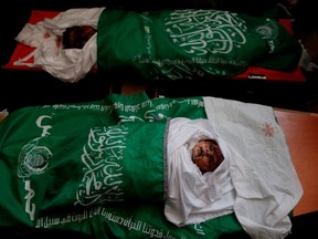 Mourners gather around the bodies of Palestinians, who were killed in Israeli strikes the previous day, during a funeral ceremony at a mosque in Beit Lahia, in northern Gaza strip on May 6 2019. - Palestinian leaders in Gaza announced a ceasefire with Israel today to end a deadly two-day escalation in violence that threatened to widen into a fourth war between them since 2008.