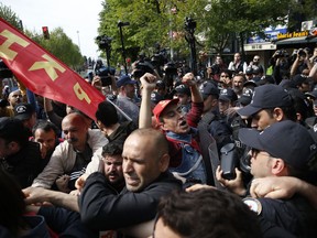 A demonstrator chants slogans as he and collegues are arrested by Turkish police officers, during May Day protests in Istanbul, Wednesday, May 1, 2019. Police in Istanbul detained several demonstrators who tried to march toward Istanbul's symbolic Taksim Square in defiance of a ban by the government, citing security concerns.