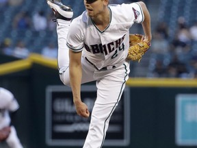 Arizona Diamondbacks starting pitcher Luke Weaver watches a delivery to a Pittsburgh Pirates batter during the first inning of a baseball game Tuesday, May 14, 2019, in Phoenix.