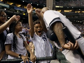 New York Yankees starting pitcher C.C. Sabathia greets his children after throwing his 3,000th career strikeout, during the second inning of a baseball game against the Arizona Diamondbacks on Tuesday, April 30, 2019, in Phoenix.