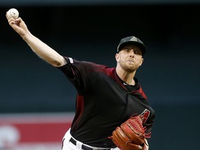 Arizona Diamondbacks starting pitcher Merrill Kelly throws against the San Francisco Giants during the first inning of a baseball game, Friday, May 17, 2019, in Phoenix.