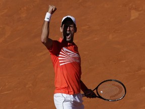 Nova Djokovic of Serbia celebrates a point during the Madrid Open tennis match against Dominic Thiem of Austria in Madrid, Spain, Saturday, May 11, 2019.