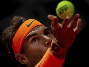 Rafael Nadal, from Spain, serves to Felix Auger-Aliassime, from Canada, during the Madrid Open tennis match in Madrid, Wednesday, May 8, 2019.