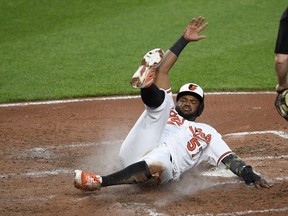 Baltimore Orioles' Hanser Alberto slides home to score a run on a single by Dwight Smith Jr. during the fourth inning of a baseball game against the New York Yankees, Monday, May 20, 2019, in Baltimore.