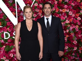 This June 10, 2018 file photo shows Amy Schumer, left, and Chris Fischer at the 72nd annual Tony Awards in New York. Schumer gave birth to a son with husband Fischer Sunday night, May 5, 2019, according to her Instagram where she posted a photo of her family of three. In the caption she writes that at '10:55 p.m. last night. Our royal baby was born.'