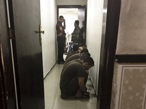 FILE - in this May 23, 2018 file photo, suspected Islamic State militants wait their turn for sentencing at the counterterrorism court in Baghdad, Iraq. A Baghdad court sentenced to death three French citizens Sunday for being members of the Islamic State group, an Iraqi judicial official said. The official said the three were among 12 French citizens handed over to Iraq in January by the U.S.-backed Syrian Democratic Forces. Then SDF has handed over to Iraq hundreds of suspected IS members in recent months.