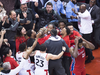 Players and fans celebrate after Kawhi Leonard’s last-second, Game 7-winning shot goes in to clinch the Toronto Raptors’ defeat of the Philadelphia 76ers, in Toronto on May 13, 2019.