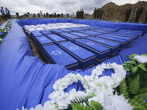 Coffins are seen before burying the remains of Holocaust victims at a cemetery just outside Brest, Belarus, Wednesday, May 22, 2019.