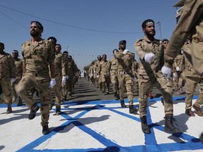 Iraqi Popular Mobilization Forces march over a representation of an Israeli flag during "al-Quds" Day, Arabic for Jerusalem, in Baghdad, Iraq, Friday, May 31, 2019. Jerusalem Day began after the 1979 Islamic Revolution in Iran, when the Ayatollah Khomeini declared the last Friday of the Muslim holy month of Ramadan a day to demonstrate the importance of Jerusalem to Muslims.