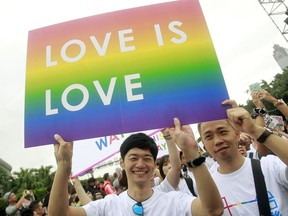 FILE - In this Saturday, Oct. 31, 2015, file photo, revelers participate in a gay pride parade in Taipei, Taiwan. Taiwanese legislators are scheduled to decide Friday on legalizing same-sex marriage, marking a potential first in Asia.