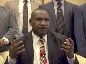 In this image made from video, Papua New Guinea's new Prime Minister James Marape speaks to media after being sworn in, Thursday, May 30, 2019, in Port Moresby, Papua New Guinea. The former finance minister Marape has been sworn in as the country's new prime minister, following the resignation of Peter O'Neill last week. (Australian Broadcasting Corporation via AP)