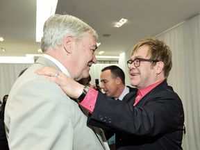 Sir Elton John, who has called Conrad Black “deeply loyal,” greets Black at the Sir Elton John and David Furnish Personal Appearance at Holt Renfrew in Toronto in 2012.