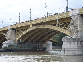 Hungarian counter terror police divers and technical teams are seen on boats on the Danube river on May 30, 2019 in Budapest during the operations to pull out of the water the "Mermaid" sightseeing boat that sank overnight after colliding with a larger vessel in pouring rain. - Hungarian police launched a criminal investigation into one of the country's worst boat accidents that left at least seven South Korean tourists dead and 21 others missing.