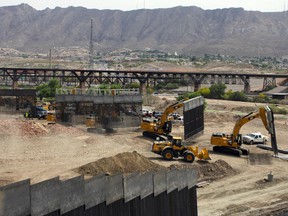 Workers build a border fence in a private property located in the limits of the US States of Texas and New Mexico taken from Ciudad Juarez, Chihuahua state, Mexico on May 26, 2019.