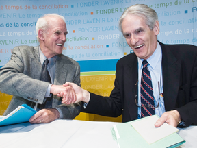 Charles Taylor, left and Gérard Bouchard shake hands after releasing their report on "reasonable accommodations," in Montreal on May 22, 2008.