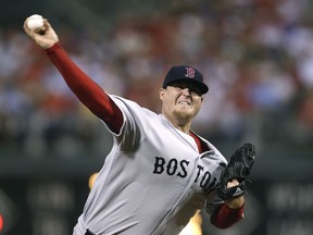 FILE - In this June 28, 2011 file photo, Boston Red Sox pitcher Bobby Jenks delivers during a baseball game against the Philadelphia Phillies in Philadelphia. Jenks reached an out-of-court settlement with Massachusetts General Hospital and the attending surgeon on Wednesday, May 8, 2019, over a December 2011 surgery he said caused his career-ending spine injury.