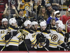 FILE - In this May 16, 2019, file photo, Boston Bruins players celebrate during the closing moments in Game 4 of the team's NHL hockey Stanley Cup Eastern Conference final victory over against the Carolina Hurricanes in Raleigh, N.C. The Bruins will face the St. Louis Blues in Game 1 of the Stanley Cup Final on Monday, May 27, 2019, in Boston.