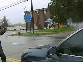 This still image from police dash camera video released Friday, May 3, 2019, by the Hartford State's Attorney shows Police Officer Layau Eulizier pointing his weapon at a car being driven at him by Anthony Jose Vega Cruz during an attempted traffic stop April 20 in Wethersfield, Conn. Eulizier shot through the windshield, striking Vega Cruz, of Wethersfield, who died two days later at a hospital. (Hartford State's Attorney via AP)